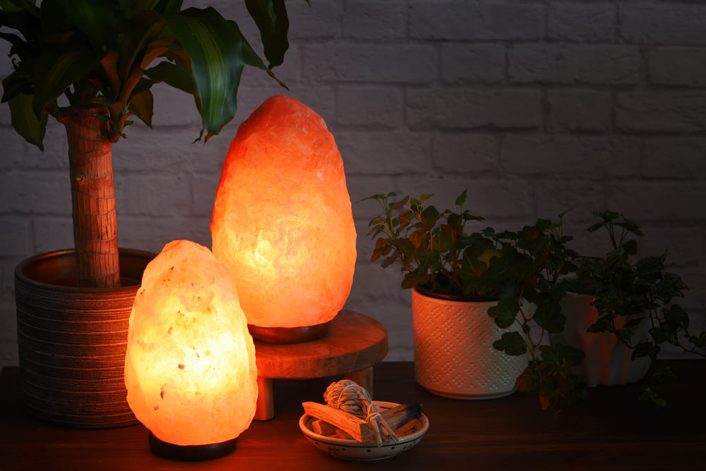 Himalayan salt lamps which can boost mood, improve sleep, ease allergies,reduce anxiety and clean the air. Warm orange colored light in dark room.