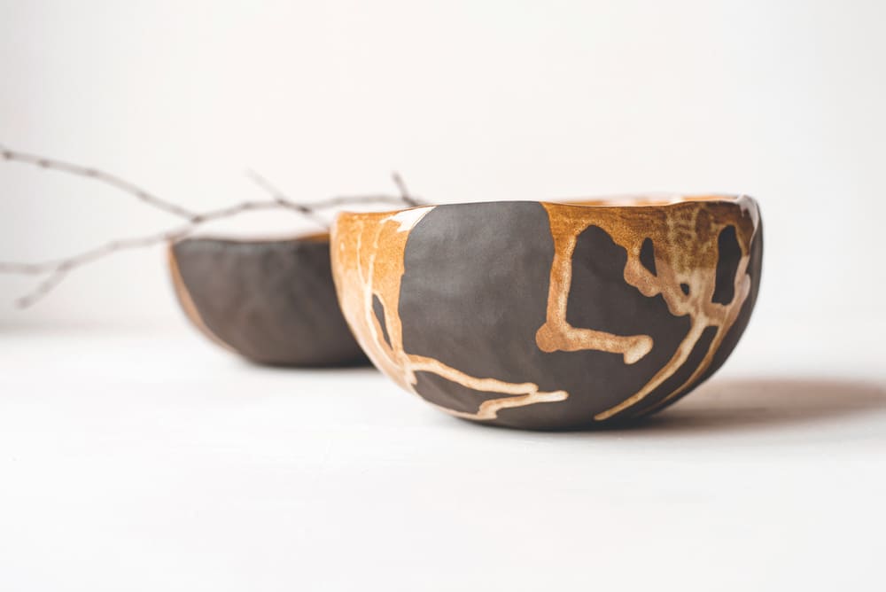 Handmade ceramics in the style of wabi sabi. Brown clay bowls with an abstract pattern.