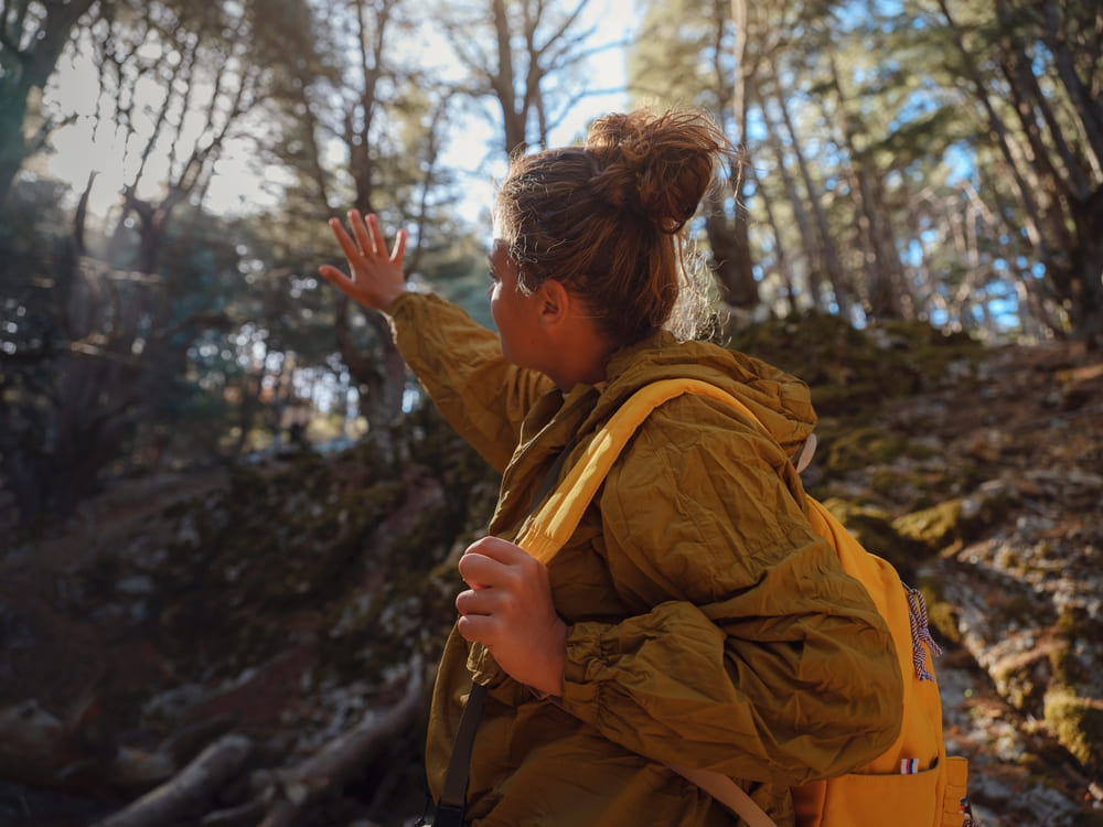 caucasian woman enjoys being in nature, beautiful forest in mountains. embracing fresh air and engaging in outdoor activities. Friluftsliv concept means spending as much time outdoors as possible